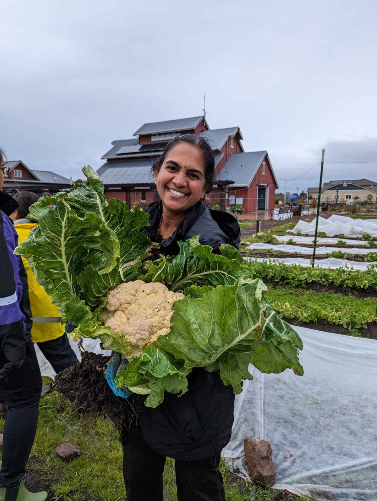 A woman holding a huge cauliflower
