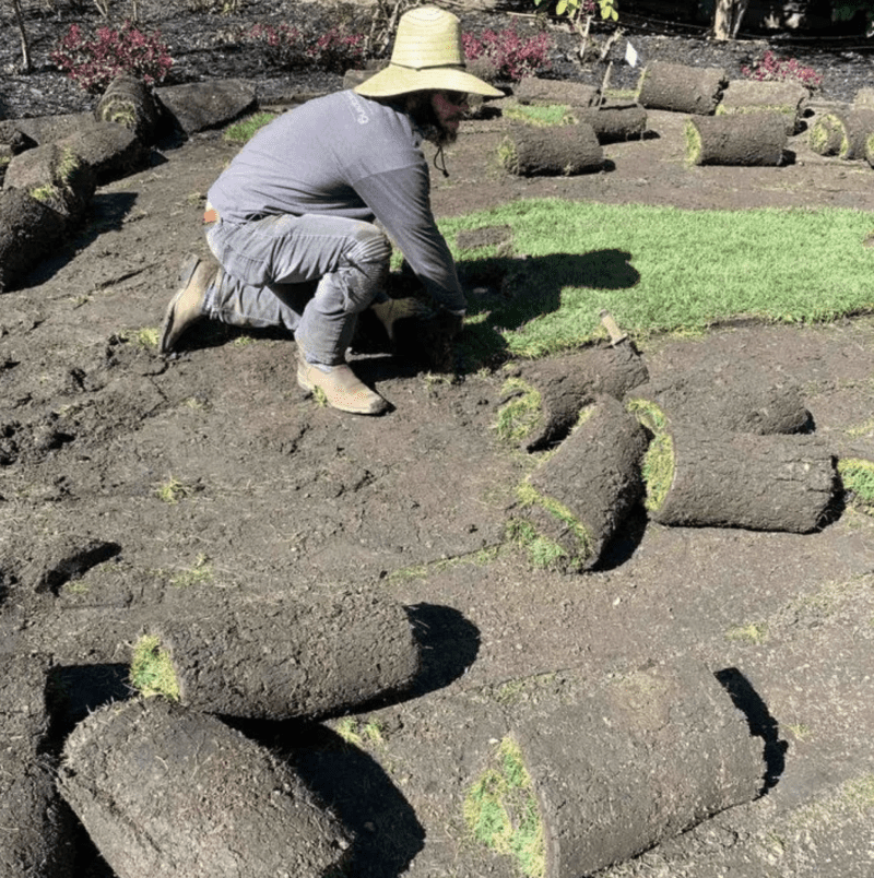 A man removing turf