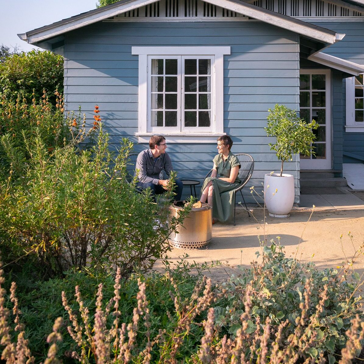 Fire pit on the patio surrounded by a pollinator garden, featuring California native plants like salvia and artemisia, chosen for their aroma.